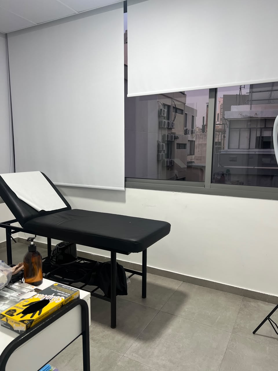 Private physiotherapy treatment bed beside a large window and white blinds